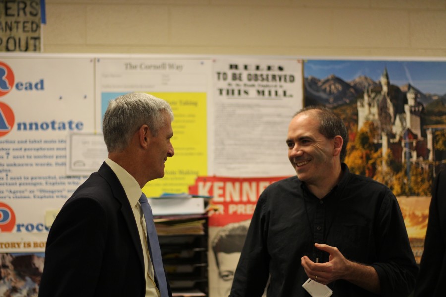 Marquette alumnus and social studies teacher, Mr. Coffey, jokes with Dr. Lovell