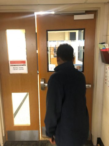 Antony (12) walks out of the library, tired of hearing about databases